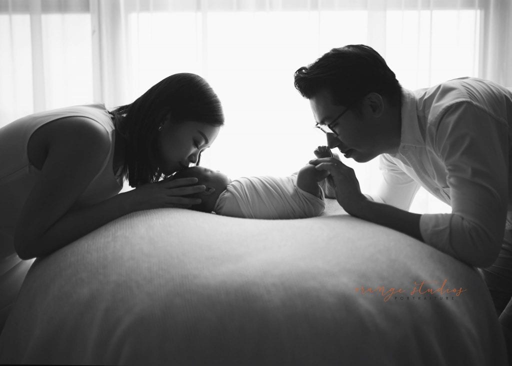 14 days old baby boy with parents black and white newborn portraits in singapore studio natural light