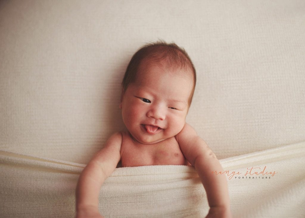 adorable 14 days old baby boy newborn portraits in singapore studio natural light