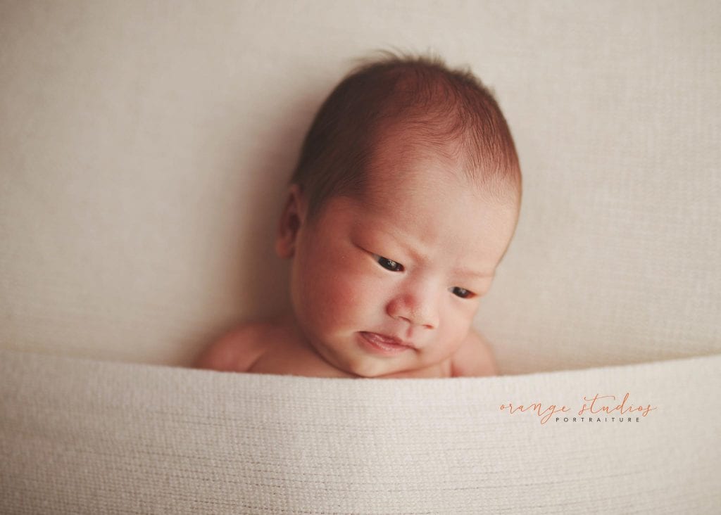 adorable 14 days old baby boy newborn portraits in singapore studio natural light