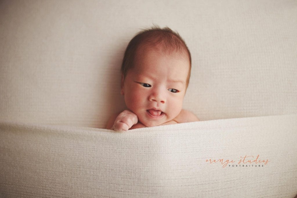 cheeky 14 days old baby boy newborn portraits in singapore studio natural light