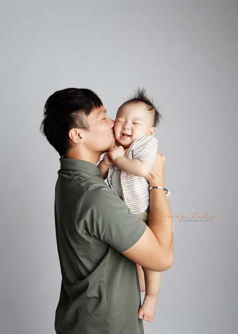 giggling 1 year old baby boy with dad family portraits in singapore studio