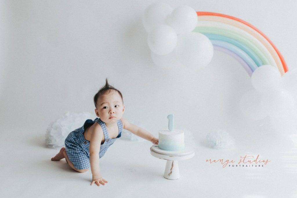 1 year old baby boy rainbow theme cake smash portraits in singapore natural light studio
