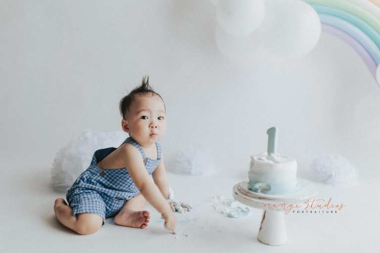 1 year old baby boy rainbow theme cake smash portraits in singapore natural light studio