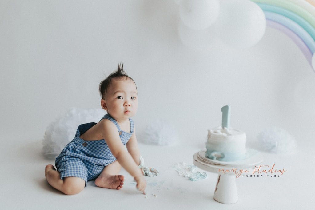 1 year old baby boy rainbow theme cake smash portraits in singapore natural light studio