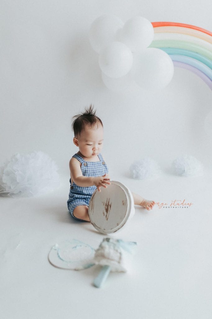 1 year old baby boy rainbow theme cake smash portraits in singapore natural light studio
