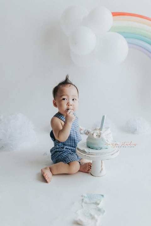 1 year old baby boy rainbow theme cake smash portraits in singapore natural light studio