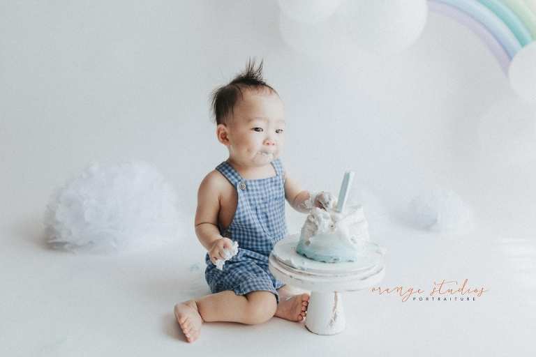 1 year old baby boy rainbow theme cake smash portraits in singapore natural light studio