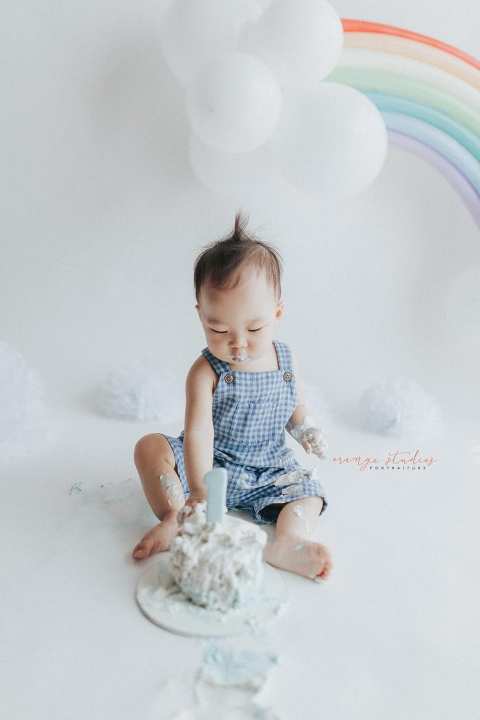1 year old baby boy rainbow theme cake smash portraits in singapore natural light studio