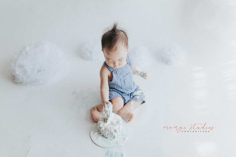 1 year old baby boy rainbow theme cake smash portraits in singapore natural light studio