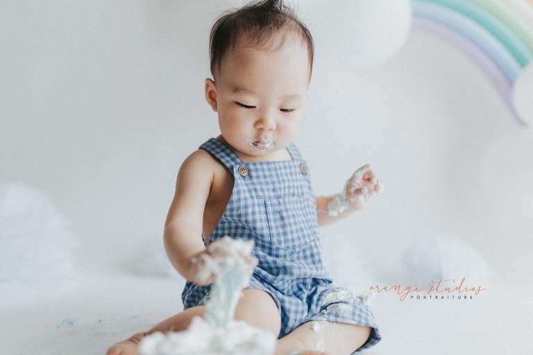 1 year old baby boy rainbow theme cake smash portraits in singapore natural light studio