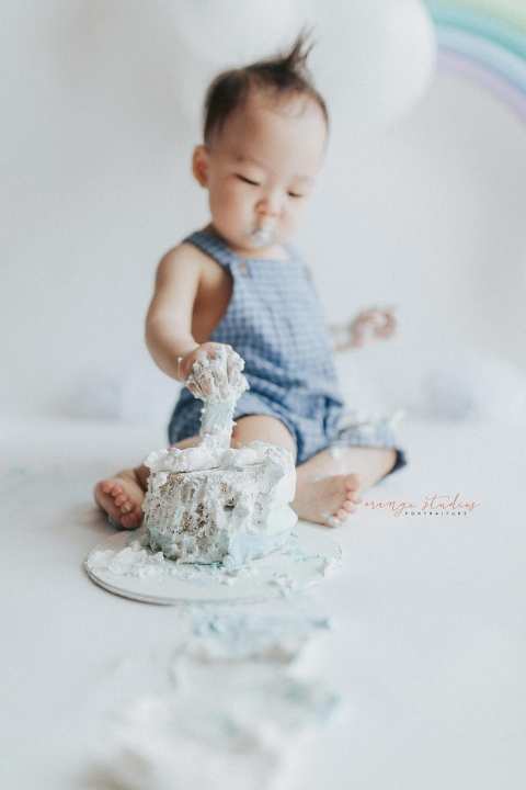 1 year old baby boy rainbow theme cake smash portraits in singapore natural light studio