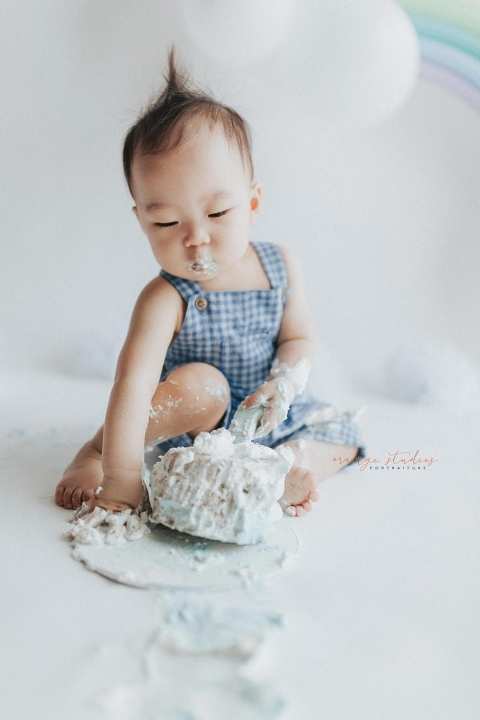1 year old baby boy rainbow theme cake smash portraits in singapore natural light studio