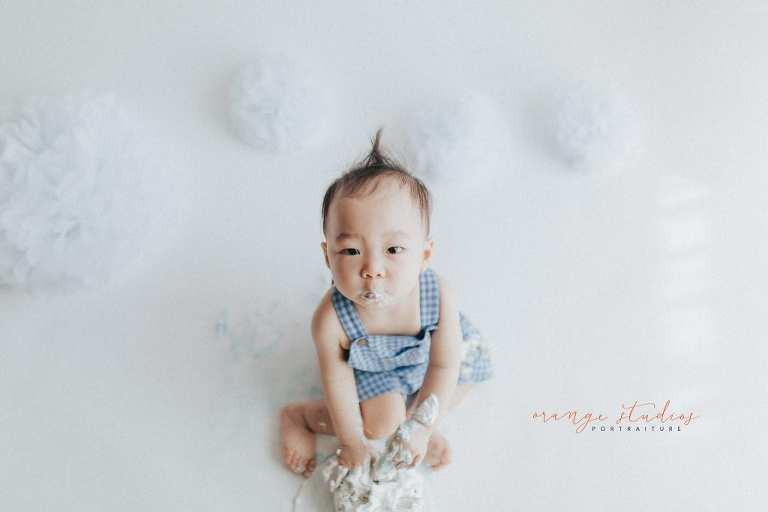 1 year old baby boy rainbow theme cake smash portraits in singapore natural light studio