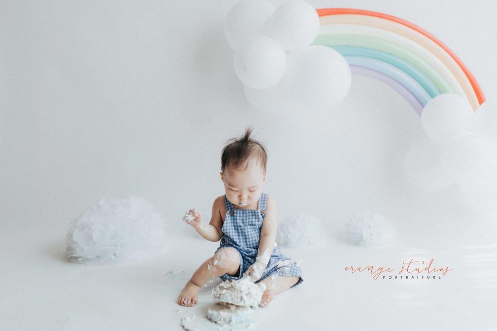 1 year old baby boy rainbow theme cake smash portraits in singapore natural light studio