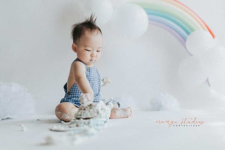1 year old baby boy rainbow theme cake smash portraits in singapore natural light studio