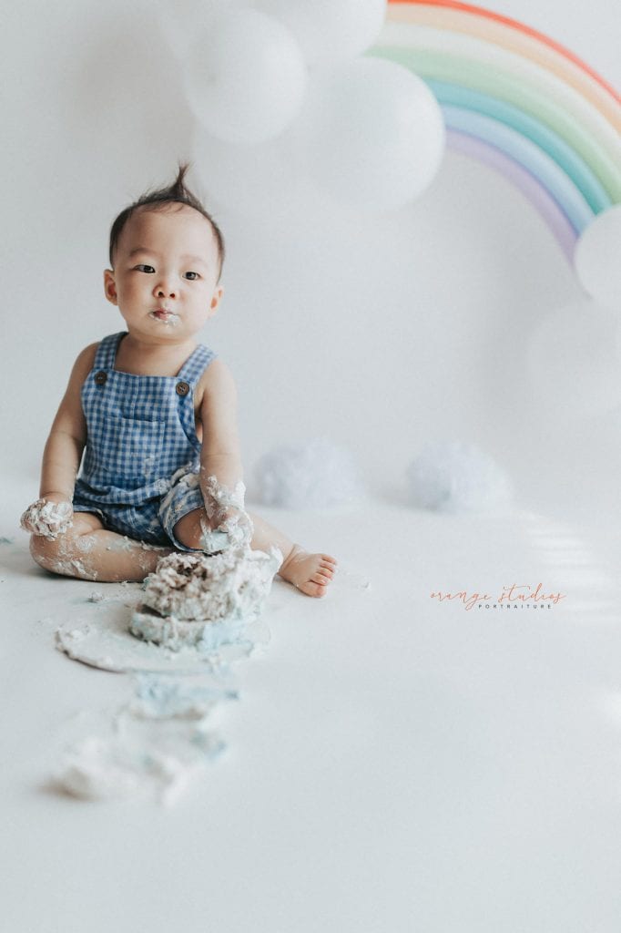 1 year old baby boy rainbow theme cake smash portraits in singapore natural light studio
