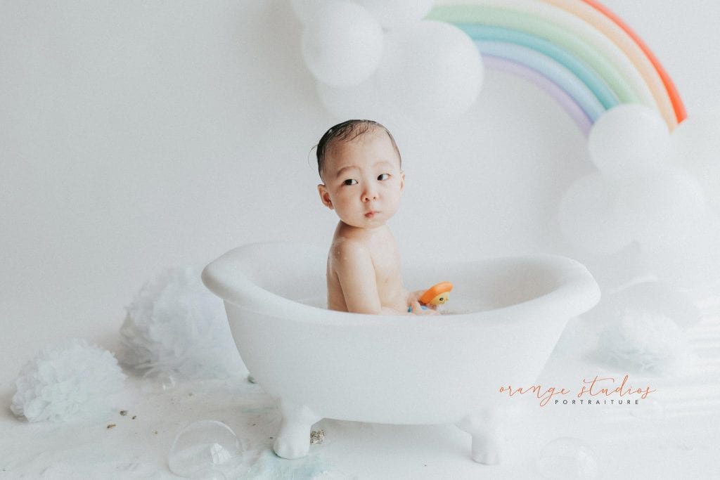 1 year old baby boy rainbow theme bubble bath portraits in singapore natural light studio