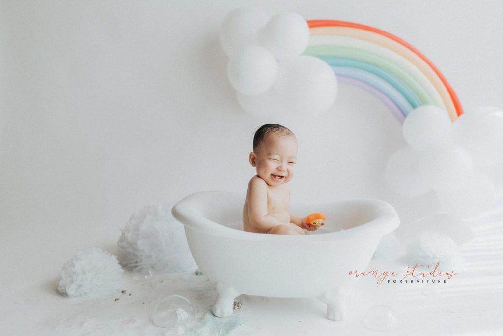 1 year old baby boy rainbow theme bubble bath portraits in singapore natural light studio
