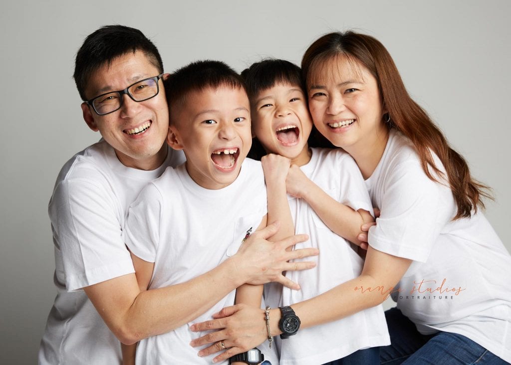 fun and natural family portraits in singapore studio