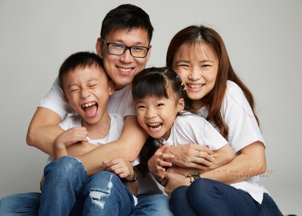 fun and natural family portraits in singapore studio