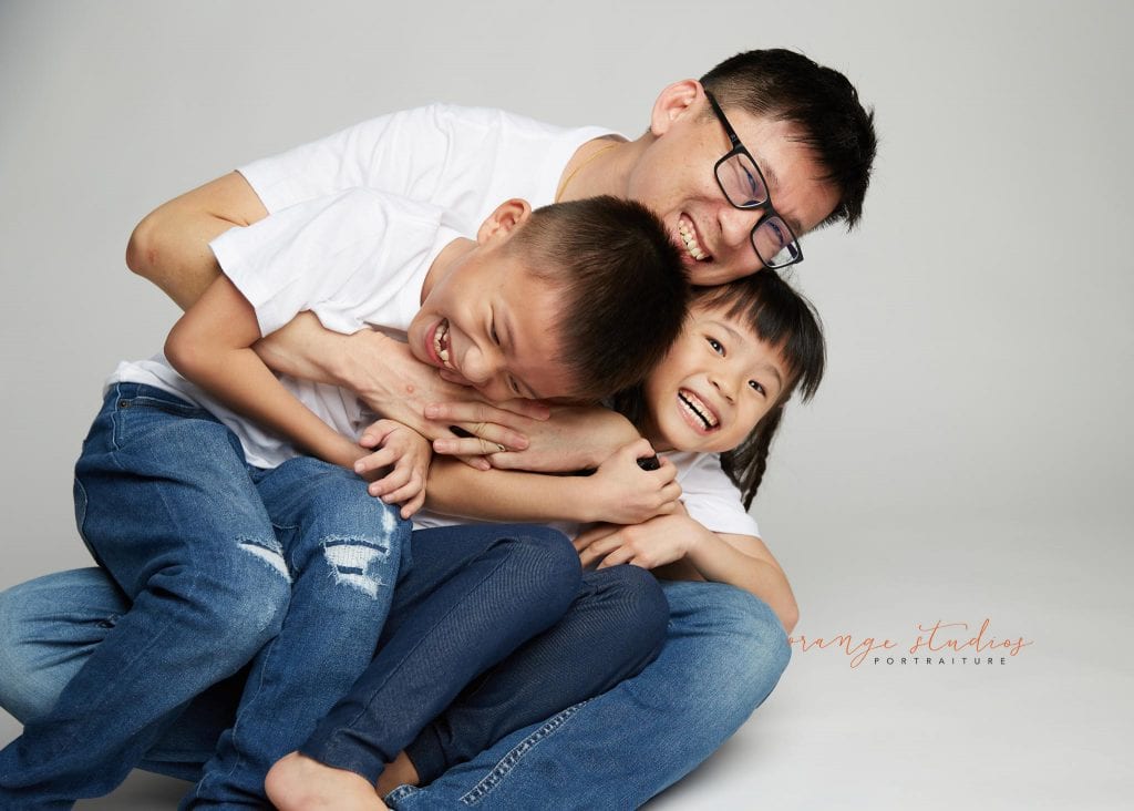 dad and kids playing family portraits in singapore studio