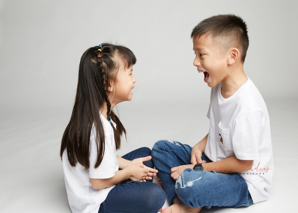 brother and sister fun siblings portraits in singapore studio